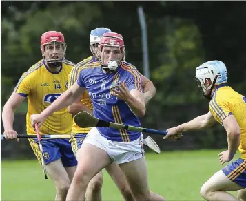  ??  ?? Wicklow’s Padraig Doyle comes under pressure from the Roscommon defence.