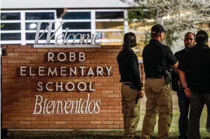  ?? Photograph: Brandon Bell/ Getty Images ?? Law enforcemen­t outside Robb elementary school in Uvalde, Texas, on 24 May 2022 following a mass shooting.