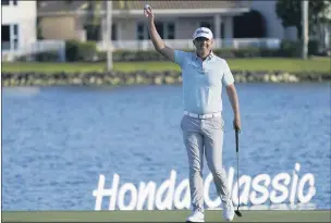  ?? MARTA LAVANDIER — THE ASSOCIATED PRESS ?? Matt Jones of Australia raises his ball after winning the Honda Classic by five strokes on Sunday at PGA National in Palm Beach Gardens, Fla. The victory put him in the Masters, which begins on April 8. Brandon Hagy finished in second place.