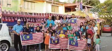  ??  ?? PENDUDUK Taman Desa Harmoni mengibarka­n Jalur Gemilang.