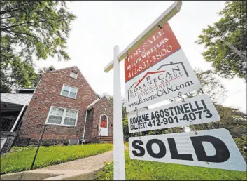  ?? Gene J. Puskar The Associated Press ?? Sales of previously occupied U.S. homes, such as this one in Mount Lebanon, Pa., bounced back in September to their strongest pace since January as the prospect of higher mortgage rates motivated buyers to get off the sidelines.