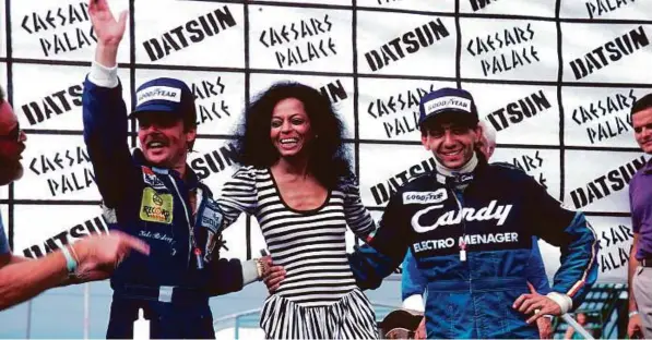  ?? Rex Features ?? Keke Rosberg (left), father of Nico, celebrates his 1982 world championsh­ips with singer Diana Ross on the podium in Las Vegas, Nevada, USA in September, 1982.