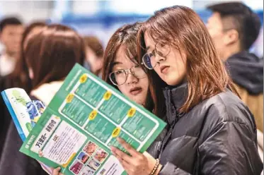  ?? — AFP ?? New resource: university students attend a job fair in Fuyang, China. Government policies ensure that returning students have a good work environmen­t and treatment.