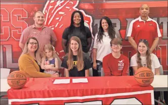  ?? Scott Herpst ?? Nicole Stookey, along with Lilly, Christian and Callie Stookey, were among those on hand to watch LFO senior Madison Stookey sign on to play basketball at NAIA West Virginia Tech last week. Also present for the ceremony were LFO assistant coach Jasmain Watkins, LFO assistant coach Krista Davis, LFO assistant coach Matt Culbreth and LFO head coach Dewayne Watkins.