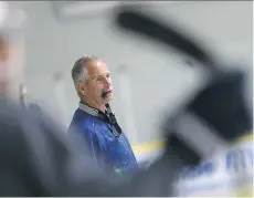  ?? MICHELLE BERG ?? Vancouver Canucks coach Willie Desjardins coaches kids Monday at the Star-Powered Kids on Ice Camp at Schroh Arena in Saskatoon.