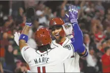  ?? AP photo ?? The Diamondbac­ks’ Lourdes Gurriel Jr. celebrates his two-run homer with Ketel Marte during the first inning of Arizona’s 16-1 victory over the Colorado Rockies on Thursday.