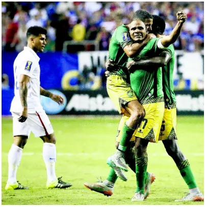  ?? FILE PHOTOS ?? Jamaica’s Rodolph Austin (facing camera) celebrates with teammates Joel McAnuff (left) and Je-Vaughn Watson, as United States’ DeAndre Yedlin walks off the pitch after Jamaica defeated the United States 2-1 in a 2015 Concacaf Gold Cup semi-final on Wednesday, July 22, 2015, in Atlanta.