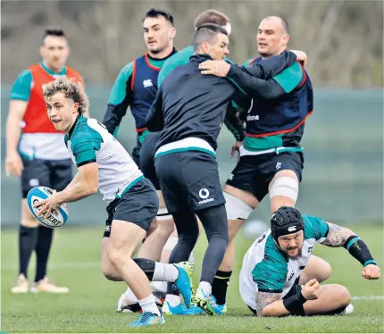  ??  ?? Getting ready: Scrum-half Craig Casey (above) prepares to offload during Ireland training and (left) assistant coach Mike Catt