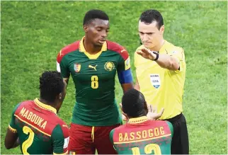  ??  ?? Colombian referee Wilmar Roldan, right, sends off Cameroon's defender Ernest Mabouka, left, after a foul during the 2017 FIFA Confederat­ions Cup group B football match between Germany and Cameroon at the Fisht Stadium Stadium in Sochi on Sunday. (AFP)