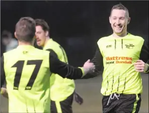  ??  ?? Muirhevnam­or’s Chris Caulfield (right), celebrates his goal with teammates.