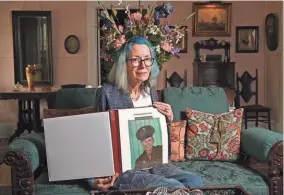  ?? ?? Judy Wade, Luther Story’s niece, is pictured on May 18 holding the scrapbook of Story that her mother put together.