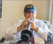  ?? Cory Rubin/The Signal ?? Arden Moser plays his trumpet in his apartment at the Sunrise Senior Living facility in Valencia.