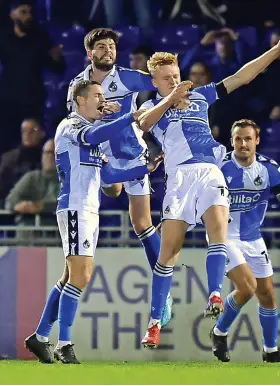  ?? ?? Rovers players jump on Connor Taylor after he cleared a header off the line