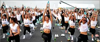  ?? AFP photo ?? Yoga enthusiast­s perform yoga during a sunrise “Brew Yoga” event on a runway at Suvarnabhu­mi Airport in Bangkok. —