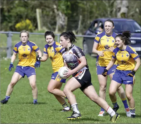  ??  ?? Ciara Gorman of Sligo wins possession despite being outnumbere­d by Clare players in Cloonacool. Pic: Tom Callanan.