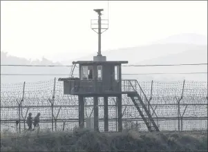  ?? AP PHOTO ?? South Korean army soldiers patrol along the barbed-wire fence in South Korea’s Paju, near the border with North Korea, Monday. North Korea vowed Monday to bolster its nuclear arsenal and launch “thousand-fold” revenge against the United States in...