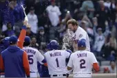  ?? ADAM HUNGER — THE ASSOCIATED PRESS ?? The New York Mets’ Pete Alonso celebrates his walkoff two-run home run with teammates during the 10th inning against the St. Louis Cardinals on Thursday in New York.