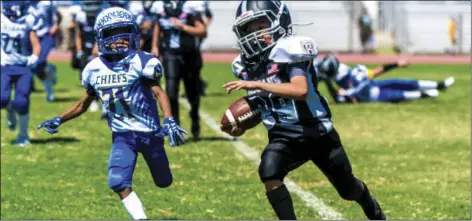  ??  ?? Jesus Cesena of the El Centro Trojans 10-and-Under football team runs the ball in for a touchdown during a home American Youth Football game against the Lake Havasu Chiefs on Saturday afternoon in El Centro. The Trojans beat the Chiefs 34-6. VINCENT OSUNA PHOTOS