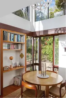  ??  ?? TOP A Line lamp by Douglas &amp; Bec, wordy work by Martin Poppelwell and tall white vase by Alvar Aalto are part of the display on the shelf in the dining area. ABOVE LEFT The All Circle dining table by Douglas &amp; Bec is teamed with Model #75 chairs by Niels Moller. ABOVE RIGHT A Liaison sofa by Nonn sits in front of the decommissi­oned fireplace decorated with a collage by Jimmy’s sister Georgina Gray. OPPOSITE Jimmy’s cousin, fine-art photograph­er Casey Moore, created the butterfly artwork that hangs on the home’s spine.