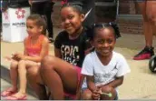  ?? ZACH SRNIS - THE MORNING JOURNAL ?? Aviana Gage, left, 6, Lei’ajah Ruffin, 9, and Aliyah Jones, 3, all from Lorain, enjoy watching the Internatio­nal Festival Parade.