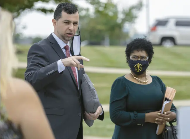  ?? MICHAEL GARD/POST-TRIBUNE ?? The only two Democrats on the redistrict­ing committee, Fady Qaddoura, of Indianapol­is, and Cherrish Pryor, also of Indianapol­is, speak to a group of protesters demanding fair redistrict­ing maps at Ivy Tech Community College in Valparaiso on Aug. 6, 2021.