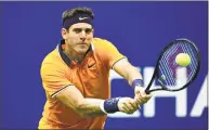  ?? Sarah Stier / Getty Images ?? Juan Martin del Potro returns the ball during against Rafael Nadal during the U.S. Open semifinals on Friday.