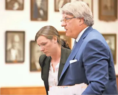  ?? MICHAEL SEARS / MILWAUKEE JOURNAL SENTINEL ?? April Novak and her attorney, Michael Hart, leave the courtroom after she entered a plea of no contest to charges that she had sex with a student while a teacher at Menomonee Falls High School. She was not sentenced at this proceeding. More photos at...