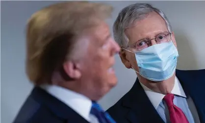  ?? ?? Mitch McConnell listens to Donald Trump on Capitol Hill in May 2020. Photograph: Brendan Smialowski/AFP/Getty Images