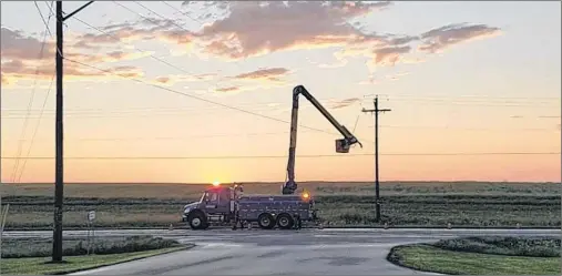  ?? 46#.*55&% 1)050 ?? This photo taken by Maritime Electric linesman Todd MacInnis shows a crew from the utility working on the power lines in Mount Albion on Friday night. An intense combinatio­n of thunder and lightning caused more than 20,000 power outages.