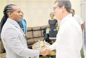  ?? CONTRIBUTE­D ?? Minister of State in the Ministry of Foreign Affairs and Foreign Trade, Alando Terrelonge (left), is greeted by Cuban Ambassador to Jamaica Fermín Quiñones during Wednesday’s ceremony for 15 Jamaican students who have gained scholarshi­ps to study in the Republic of Cuba. The event was held at the Embassy of Cuba in St Andrew.