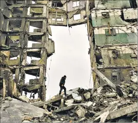  ?? AP/FILE ?? A resident looks for belongings in an apartment building destroyed during fighting between Ukrainian and Russian forces in Borodyanka, Ukraine, on April 5.