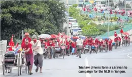  ??  ?? Trishaw drivers form a caravan to campaign for the NLD in Yangon.