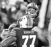  ?? BRYNN ANDERSON/AP ?? Auburn quarterbac­k Jarrett Stidham, top, reacts after scoring a touchdown during against Alabama Saturday.