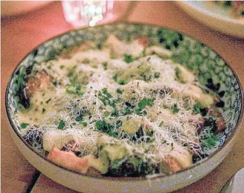  ??  ?? The brussels sprouts caesar salad at Fork restaurant in Witless Bay, N.L. is a buttery comforting dish covered with grated Parmesan cheese.