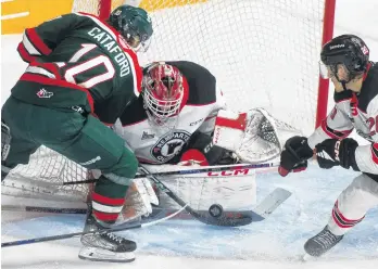  ?? RYAN TAPLIN ■ THE CHRONICLE HERALD ?? Halifax Mooseheads forward Mathieu Cataford barges in on Quebec Remparts goalie William Rousseau during the first period of Game 4 in the QMJHL final series in Halifax on Wednesday.