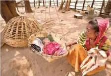  ?? G.N. RAO ?? Gentle lullaby: A baby sleeps in a bamboo cradle woven by his father at Chukkalapa­du settlement of the Muria tribe.