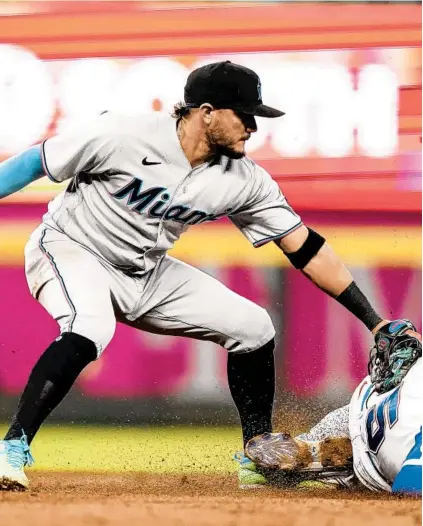  ?? BRYNN ANDERSON/AP ?? Marlins shortstop Miguel Rojas tags out Atlanta’s Freddie Freeman during the Marlins’ win Wednesday night. The Marlins lost to Atlanta Thursday, 7-6, but won three of four in the series.