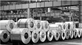  ?? ALEXANDER KOERNER/GETTY IMAGES ?? Rolled steel coils are seen in storage at a mill of German steel producer Salzgitter AG on Thursday in Salzgitter, Germany. Salzgitter is one of Europe's biggest steel makers and recorded better-than-expected profits in preliminar­y results for 2017.