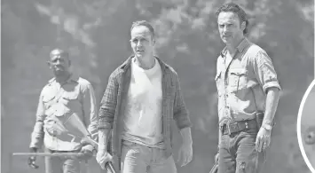  ?? PHOTOS BY GENE PAGE, AMC ?? Morgan Jones (Lennie James, left), Carter (Ethan Embry) and Rick Grimes (Andrew Lincoln) must adjust to changing threats in the new season of The Walking Dead.