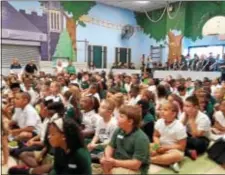  ?? BARBARA ORMSBY — DIGITAL FIRST MEDIA ?? Students at Woodlyn Elementary School wait for the unveiling of musical instrument­s that will mean the restart of the music program at Woodlyn and Eddystone elementary school thanks to a generous grant from VH1 Save the Music Foundation and Urban...