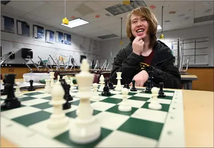  ?? JENNY SPARKS — LOVELAND REPORTER-HERALD ?? Loveland High School senior Jacob Findley thinks about his next move Monday, while demonstrat­ing some of his chess skills at his school in Loveland. He tied for third place at the Colorado Scholastic State Chess Championsh­ip.
