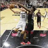  ?? ERIC GAY / ASSOCIATED PRESS ?? Rockets center Clint Capela (right) blocks a shot by Spurs forward David Lee in Monday’s Game 1 of the Western Conference semifinals in San Antonio. Capela had 20 points and 13 rebounds in Houston’s win.