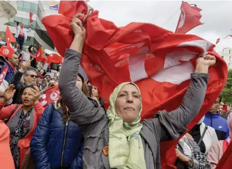  ?? File/AFP ?? Tunisian demonstrat­ors chant slogans and wave their country’s national flag in support of President Kais Saied in the capital Tunis.