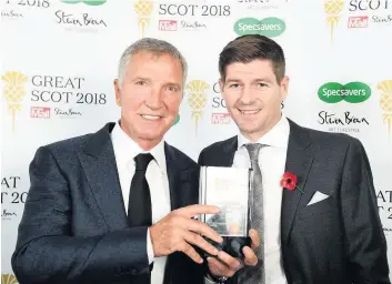  ??  ?? Great Scot Graeme Souness was presented with his lifetime achievemen­t award by Steven Gerrard