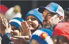  ??  ?? J.B. Bissell and his wife, Michelle, watch their son Dade play for the undefeated and top-ranked Cherry Creek Bruins last weekend.