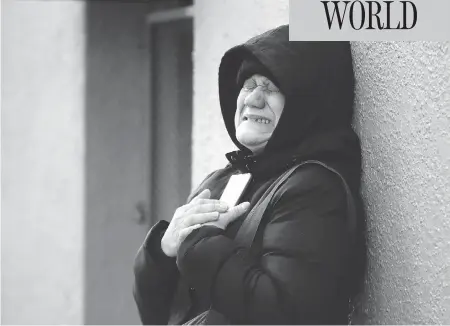  ?? JULIO CORTEZ / THE ASSOCIATED PRESS ?? Nilda Guerrero, a friend of the superinten­dent of an apartment building where 12 people died in a fire on Thursday, cries after trying to visit the Bronx building. New York City’s deadliest residentia­l fire in decades was accidental­ly lit by a boy,...