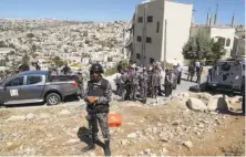  ?? Raad Adayleh / Associated Press ?? Troops secure the area in the city of Salt where a building partially collapsed in a clash between militants and soldiers.