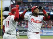  ?? MICHAEL PEREZ — THE ASSOCIATED PRESS ?? The Phillies’ Maikel Franco, right, celebrates with Rhys Hoskins after hitting a grand slam in the first inning of Saturday’s game against the Miami Marlins.