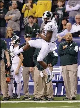  ??  ?? Michigan State wide receiver Aaron Burbridge (16) makes a catch during the Big Ten Conference championsh­ip NCAA college football game against Iowa.