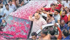  ??  ?? LOTUS BLOOMS – ALMOST BJP’s man of all seasons Amit Shah being greeted just before the Cong-JD(S) announced their decision to stake claim.